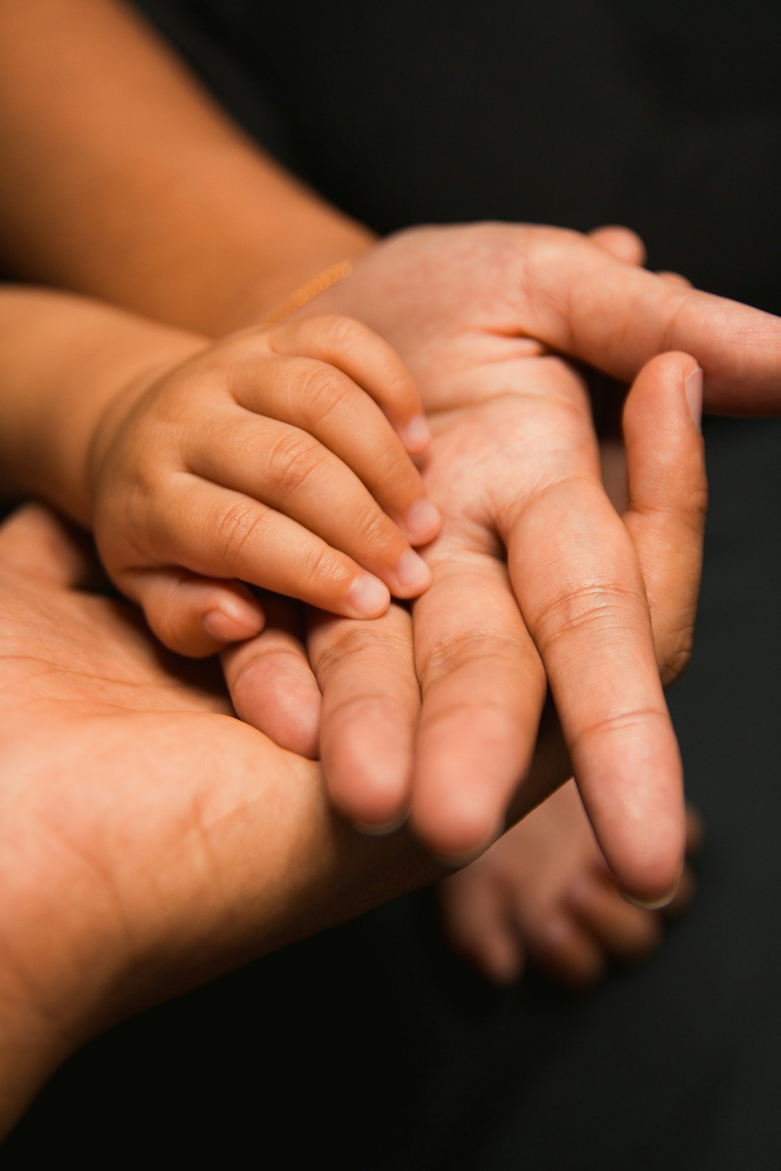 Family hands held together with care
